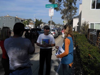 Ellen engages a citizen in conversation about the effects of climate change on sea-level,