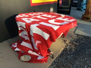 The end of the banner, with it's message of justice drapes a table. 