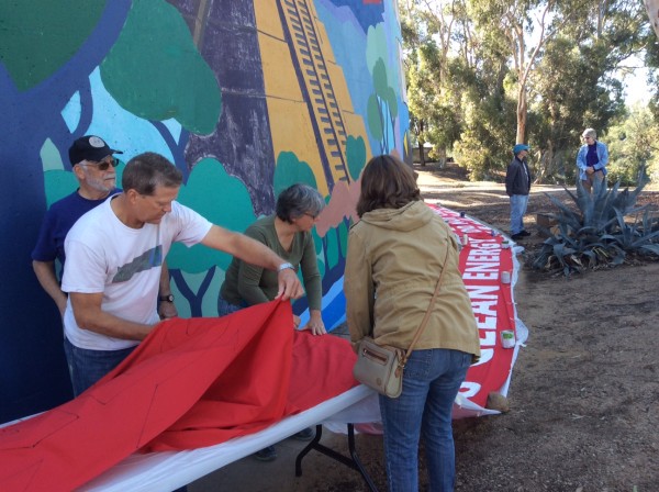 Getting ready to move the freshly painted banner to the drying area