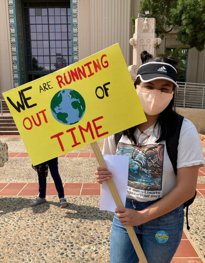 Tina Tran holding a protest sign.