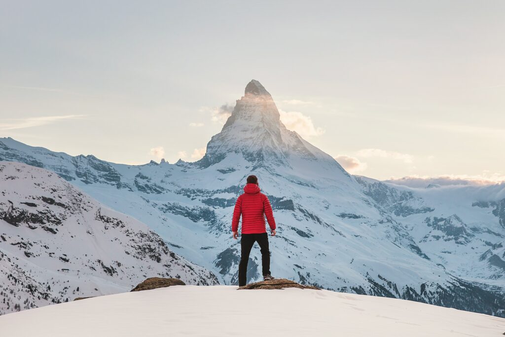 Person standing on a snowy mountain.