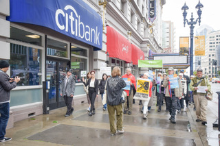 People rallying outside of Citibank