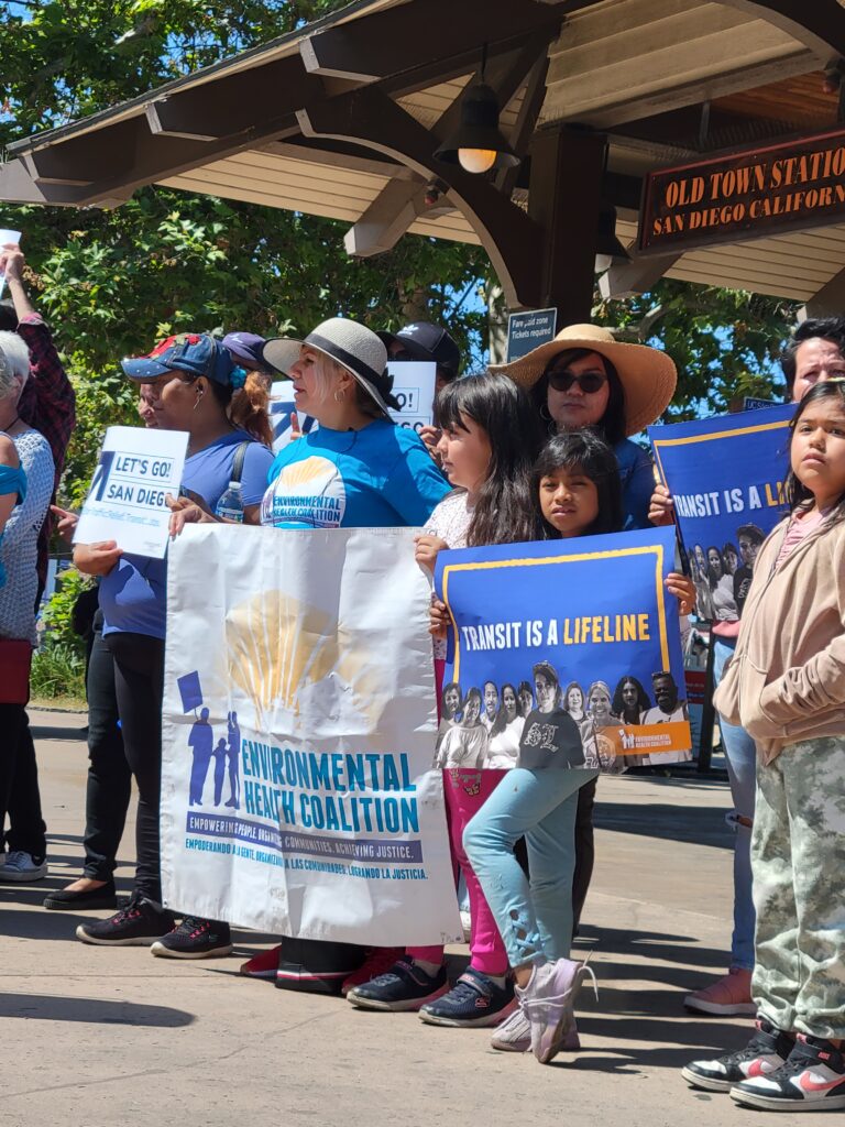 A little girl holding up a sign that says, transit is a lifeline.