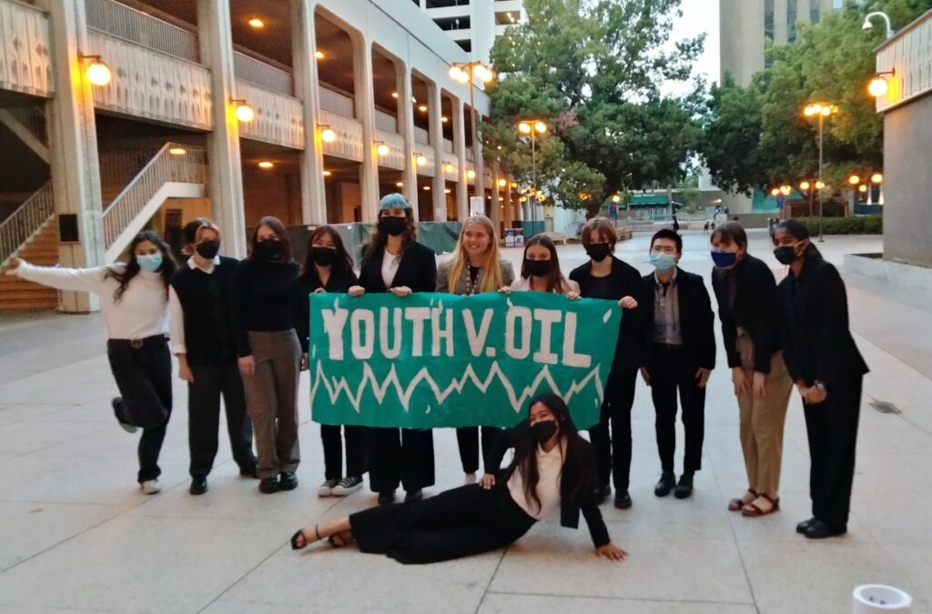 A group of youth holding a Youth v. Oil sign.