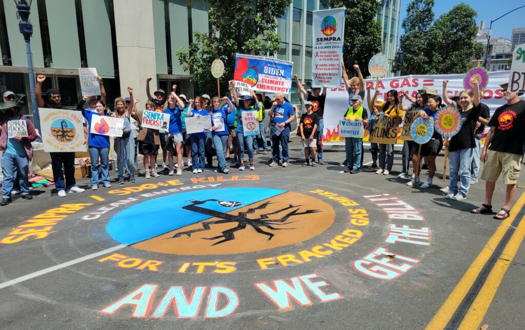 Protesters standing behind the chalk art