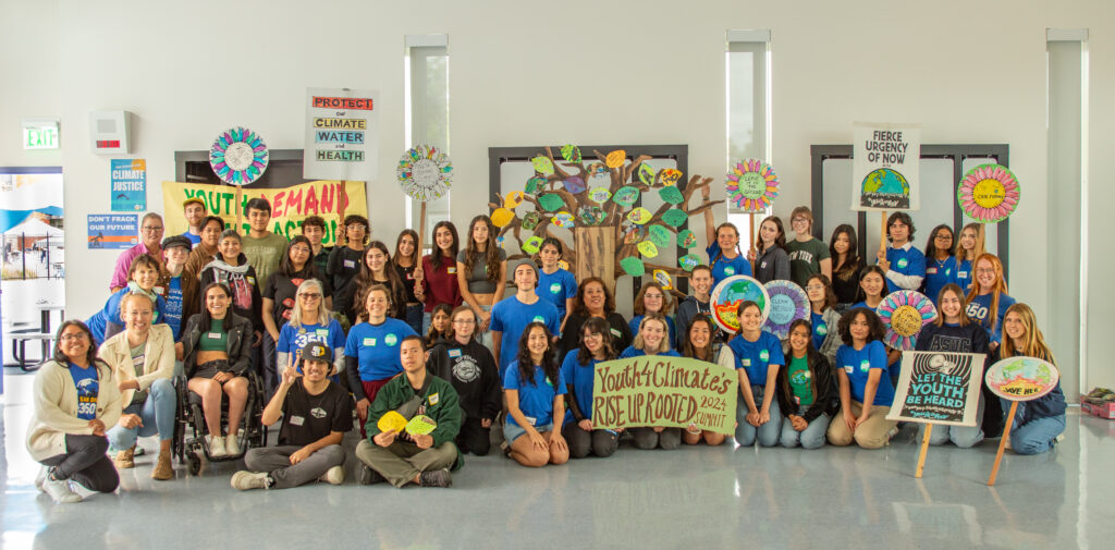 Group photos of all the students holding signs at the summit