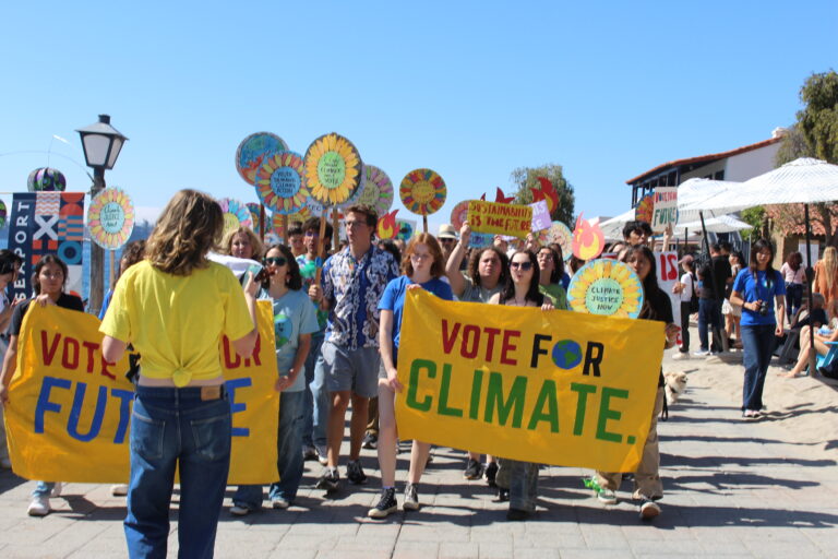 Youth rally, students holding a sign that says "Vote for Climate".