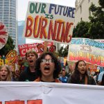 Youth chanting with signs and banners at the march