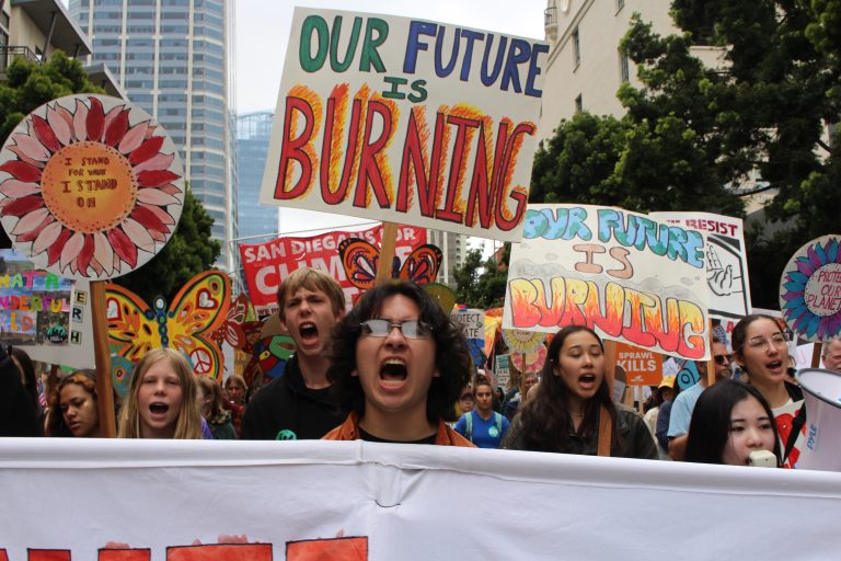 Youth chanting with signs and banners at the march