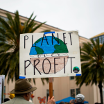 Protest sign that says "planet over profit"