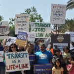 Group of people holding signs about transportation
