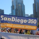 People holding a banner that reads "SanDiego350 Climate Change Action"