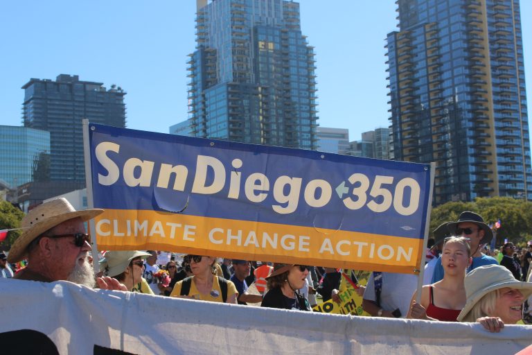 People holding a banner that reads "SanDiego350 Climate Change Action"