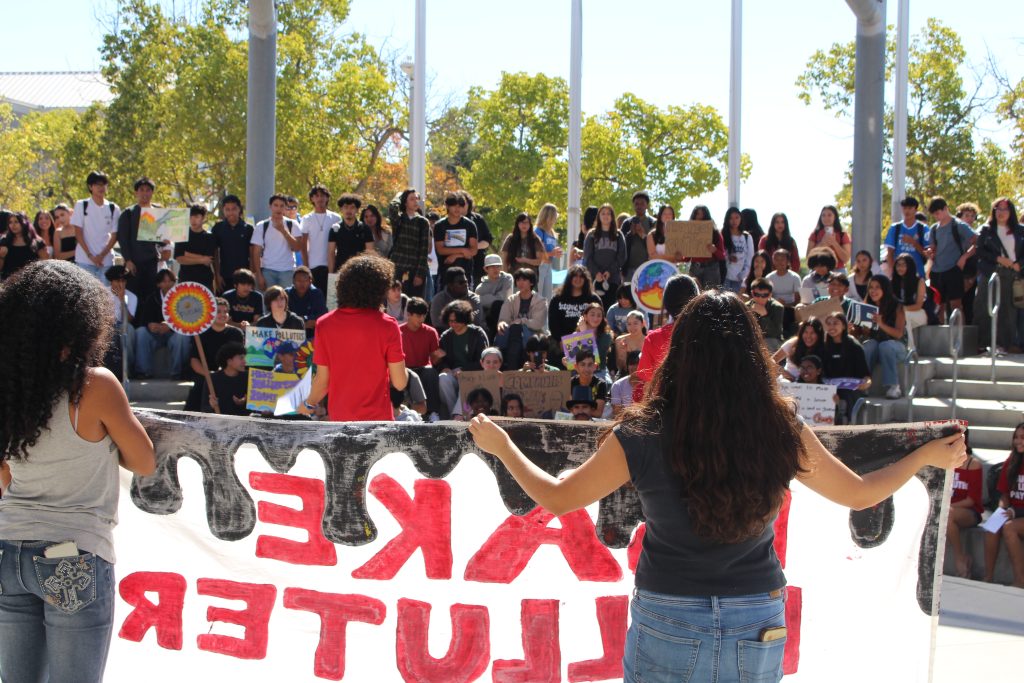 Youth member speaking to a stadium of students