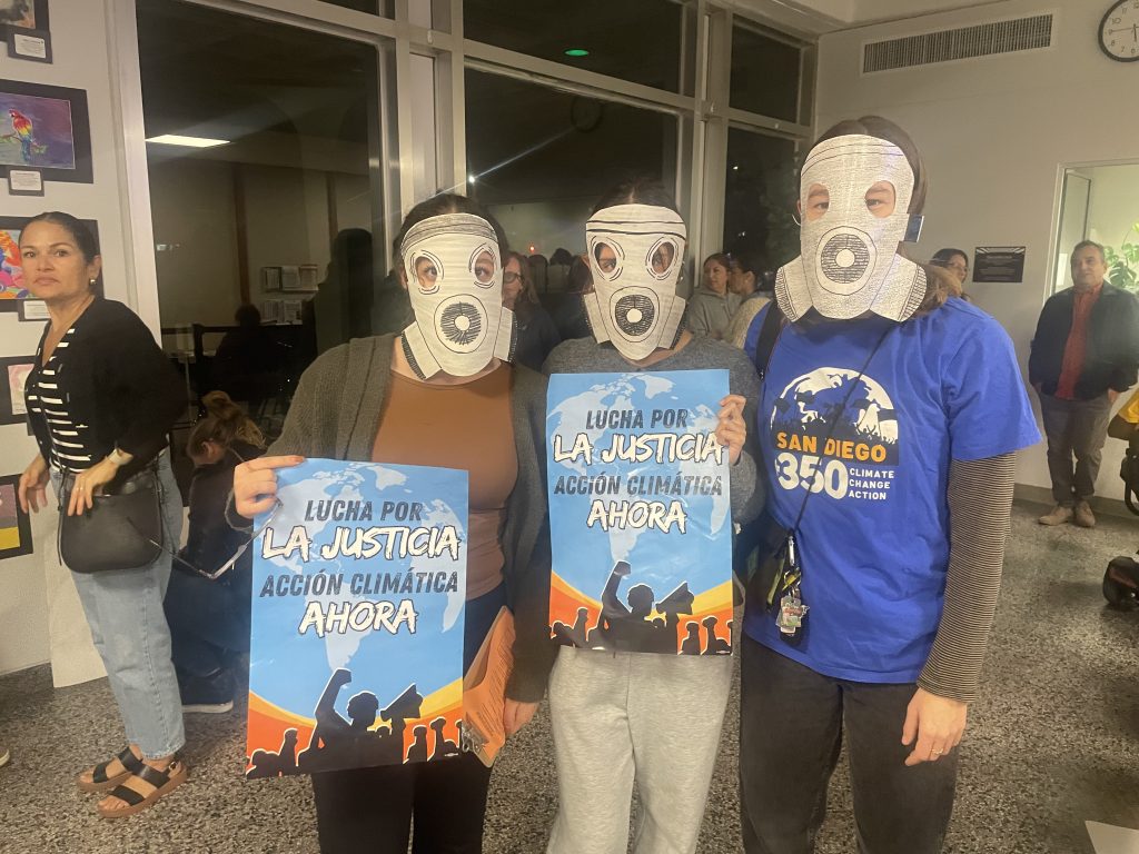 SD350 holding signs and wearing gas masks