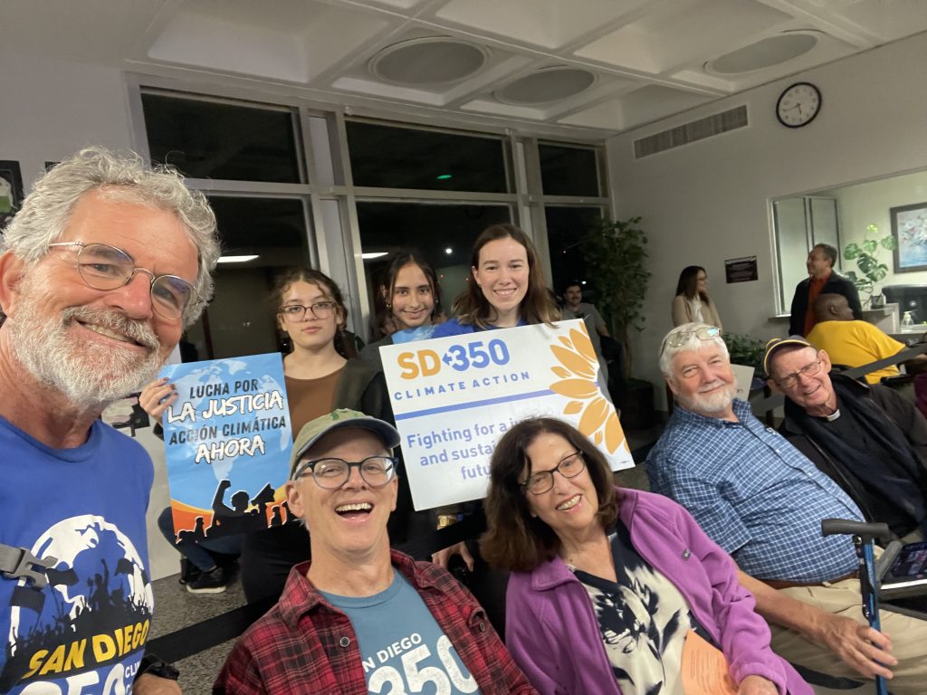 SD350 members smiling and holding signs