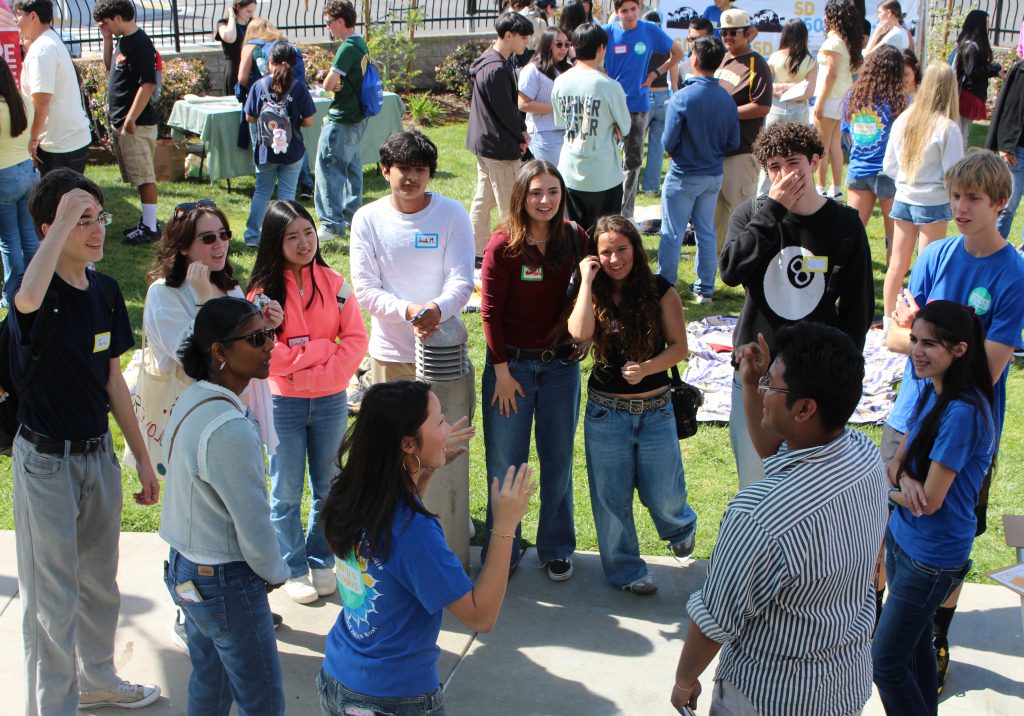 Youth in circle outside smiling and having fun