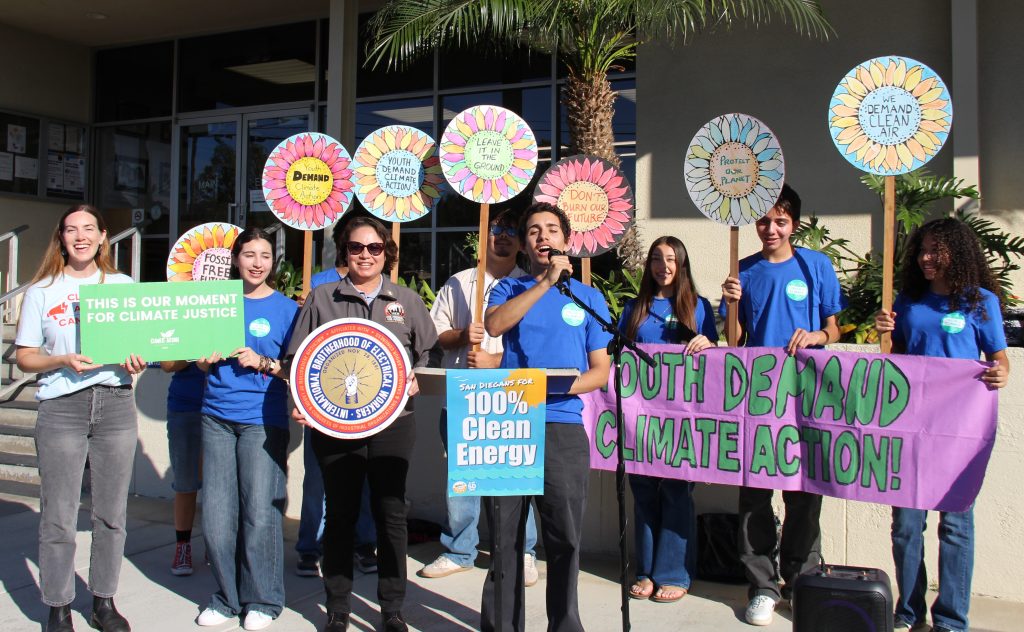 Youth holding sunflower protest signs